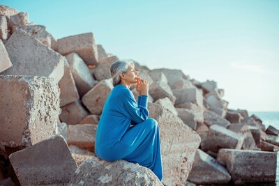 older woman sitting on rocks