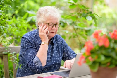 Older woman on the phone and computer