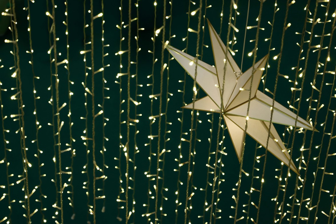 Gold string of lights, gold star on a green background